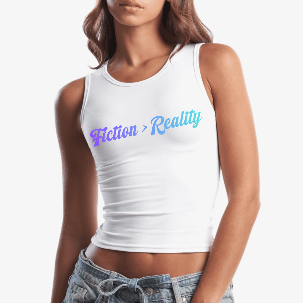 A woman wearing a white tank top with the text 'Fiction > Reality' printed across the chest in a purple-to-blue gradient, paired with light-wash denim jeans against a plain white background.