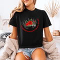 A woman wearing a black boxy crop shirt that has a crown and reads "My immune system is the real villain" 