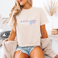 A woman wearing an Ivory boxy crop that reads "My body is tired" and has a sword underneath