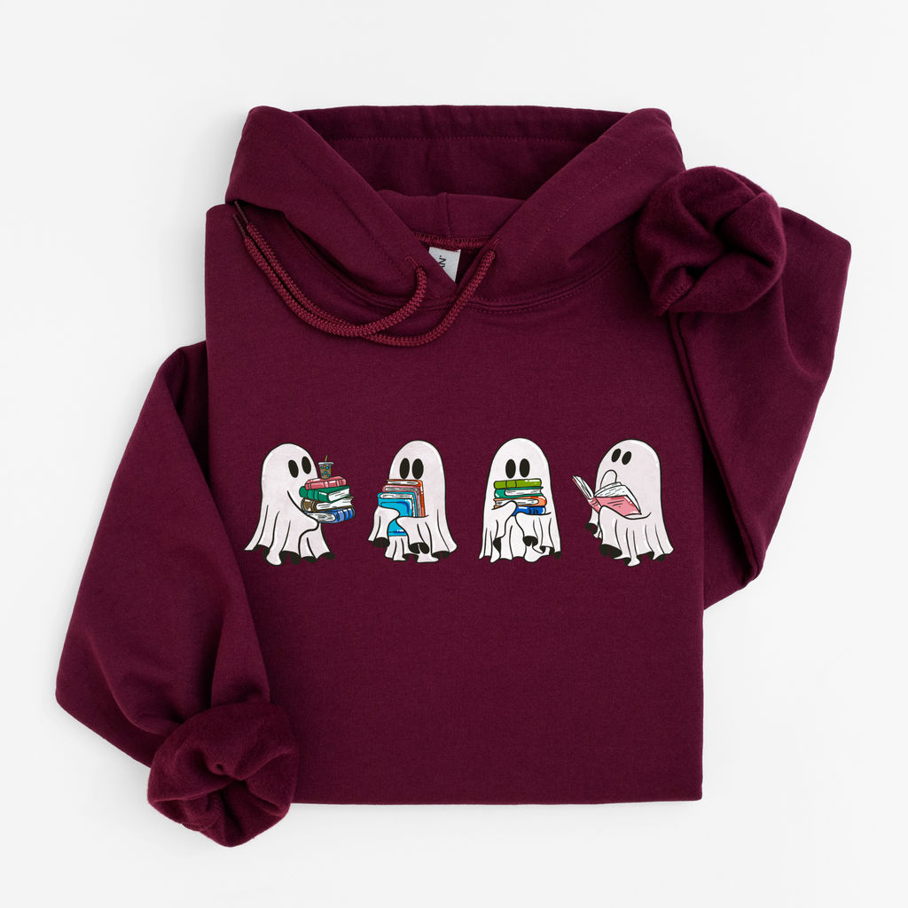 A maroon pullover hoodie with a graphic of four cartoon ghosts holding books, displayed flat against a light gray background.