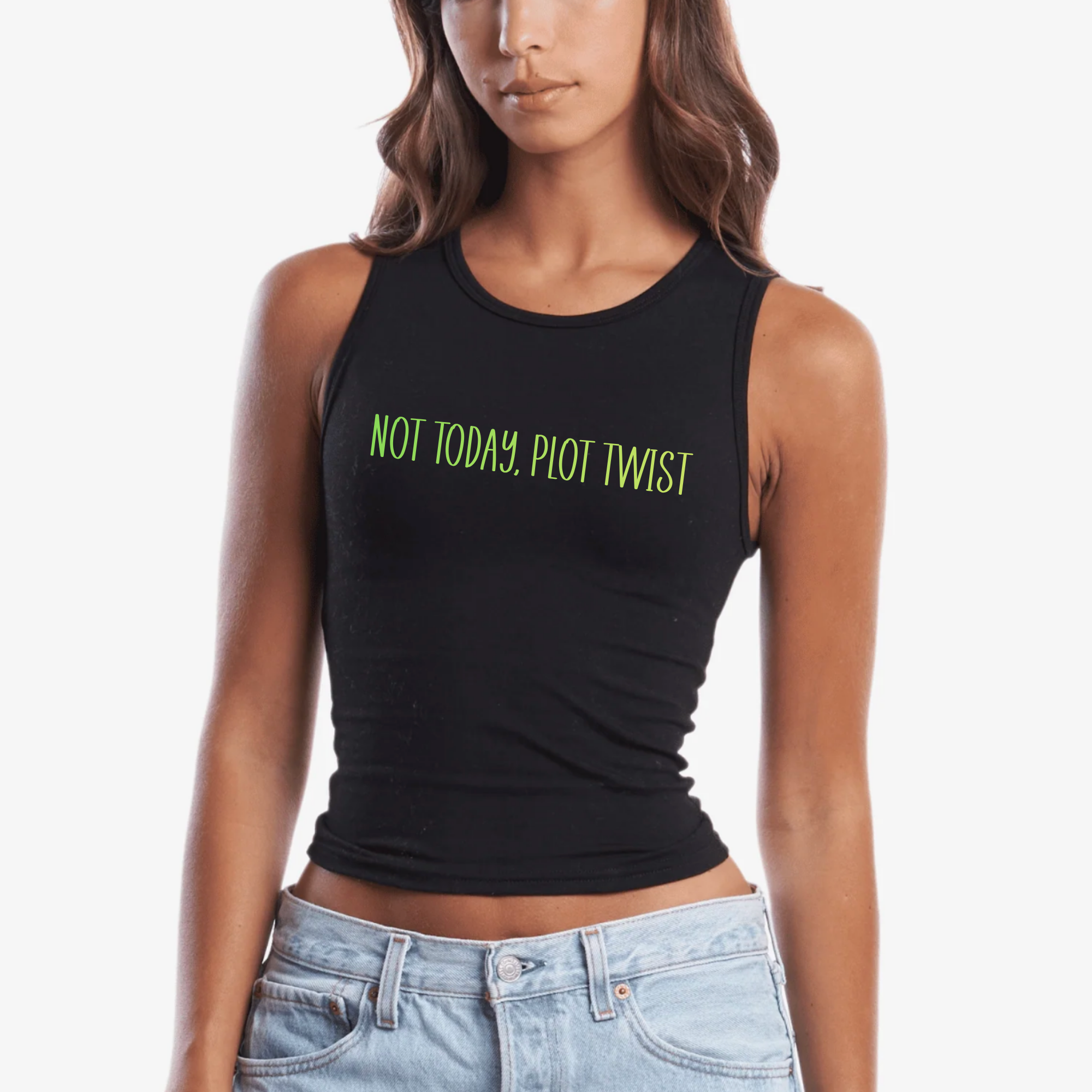 A woman wearing a black sleeveless crop tank top with the phrase 'NOT TODAY, PLOT TWIST' printed in bright green across the chest, paired with light blue jeans against a plain white background.